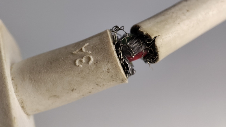 A USB cable that is frayed towards the connector