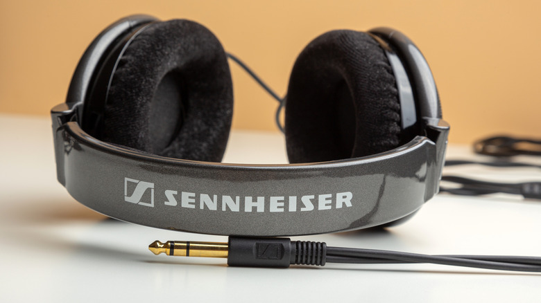 Sennheiser headphones on a white table, its audio jack visible in front