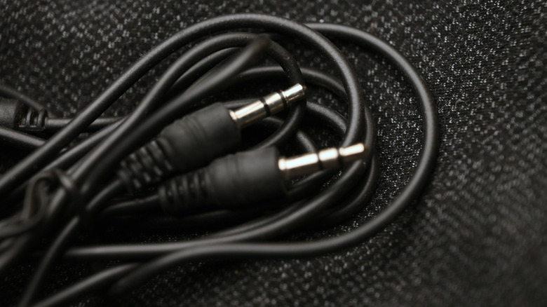 3.5mm audio cable on black fabric background