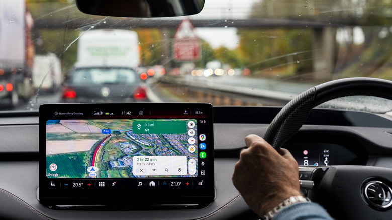 Google Maps interface on vehicle dashboard with ETA visible.