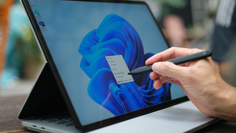 Someone using Windows 11 on a tablet with a stylus in hand.