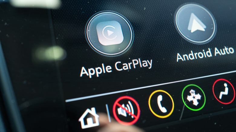 A car infotainment system with buttons for Apple CarPlay and Android Auto