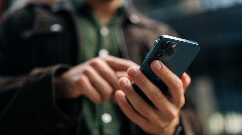 A picture of a man using a phone