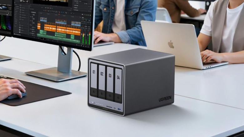 A UGREEN NAS device in an office workspace.