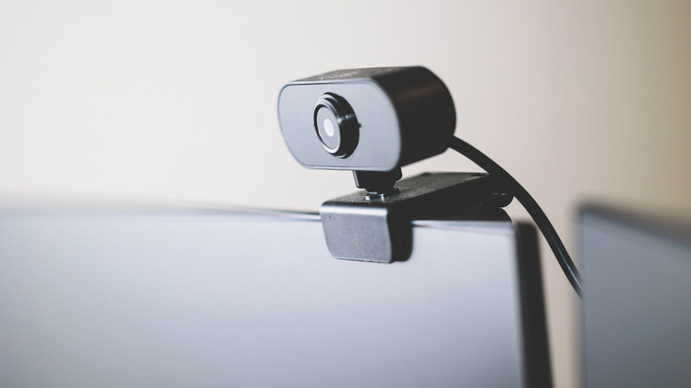 Close up of a black webcam on top of a black monitor