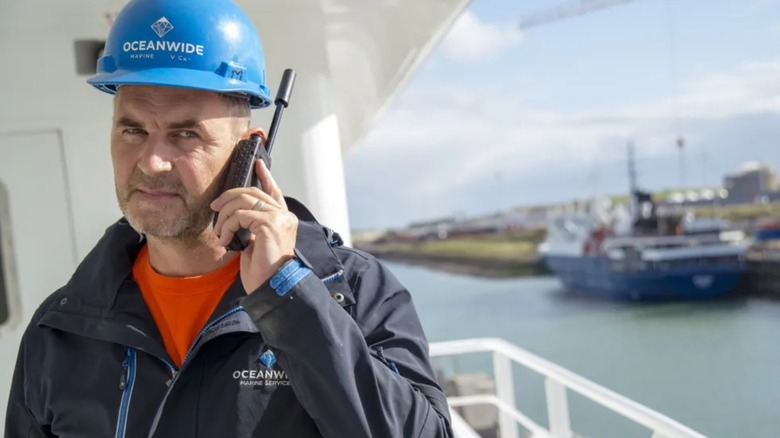 Dock worker talking on Iridium Extreme satellite phone