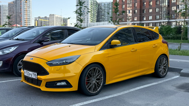 a yellow Ford Focus in a parking lot