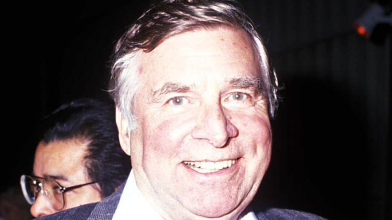 A photo of Star Trek creator Gene Roddenberry smiling at the camera