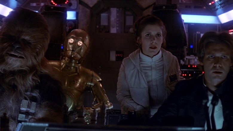 C-3PO and the crew of the Millennium Falcon look out the front of the ship