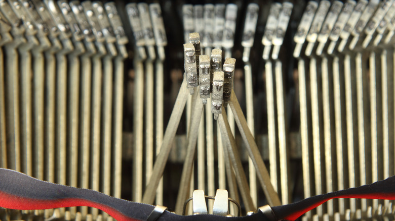 A typewriter's metal bars jammed together.