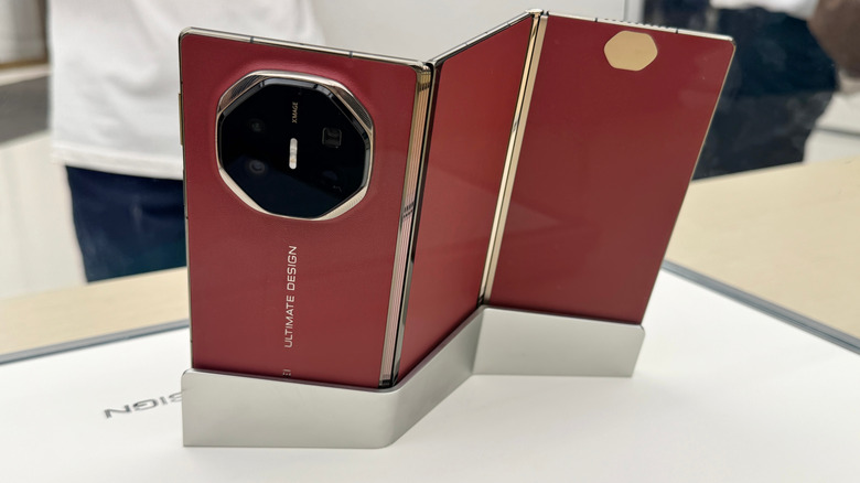 The Huawei Mate XT, the first tri-fold phone, shown on a display stand