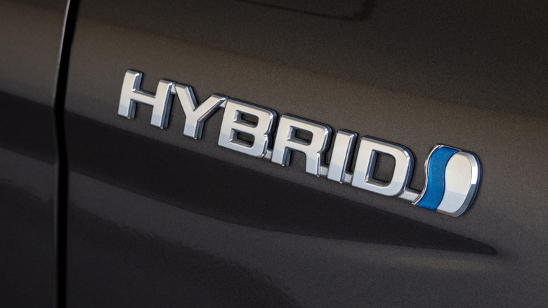 Close up of a hybrid badge on a car