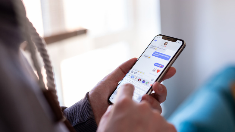 A person typing an iMessage in the Messages app.