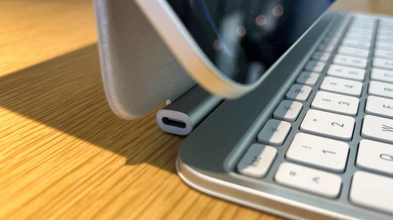 An iPad attached with a Magic Keyboard and close up of the USB-C port