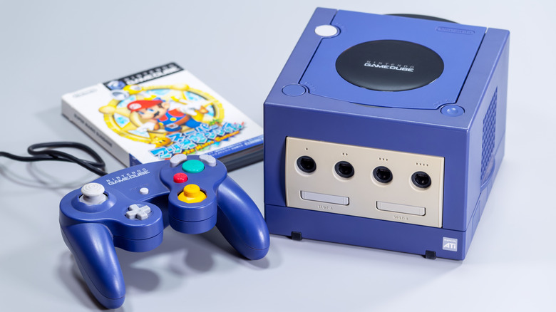 A Nintendo GameCube next to its controller and a Japanese copy of 