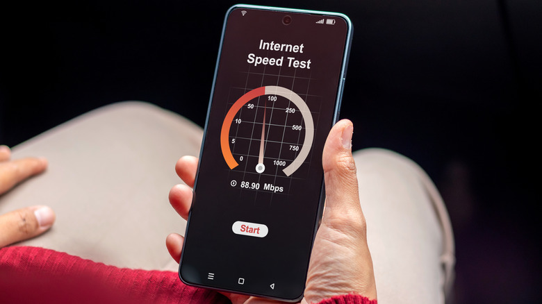 person running an internet speed test on a smartphone held in hand