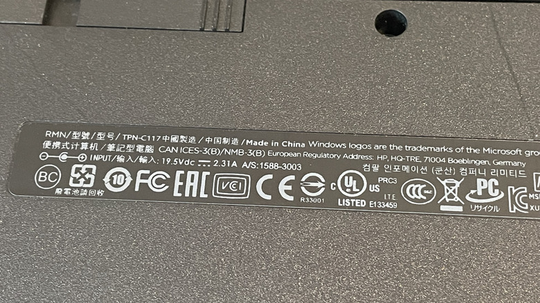 Closeup image of a warning label on the back of a laptop showing a series of symbols.