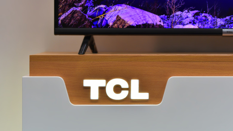 A TCL display with a TCL TV placed on top of it.