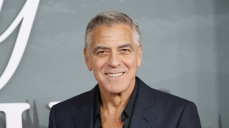 George Clooney smiling at the premiere for Jay Kelly