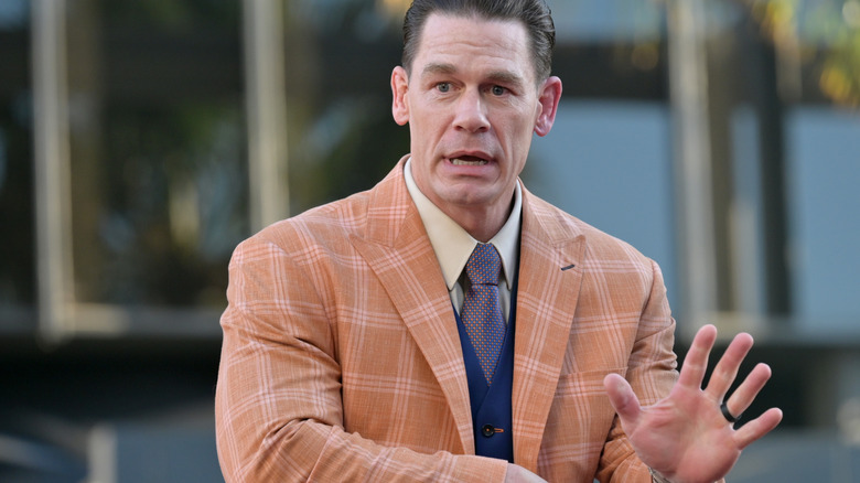 John Cena wearing a suit while attending a movie premiere.