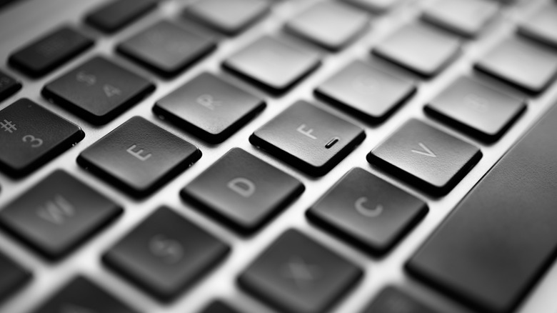 A QWERTY keyboard showing an 'F' key with a slight raised bump