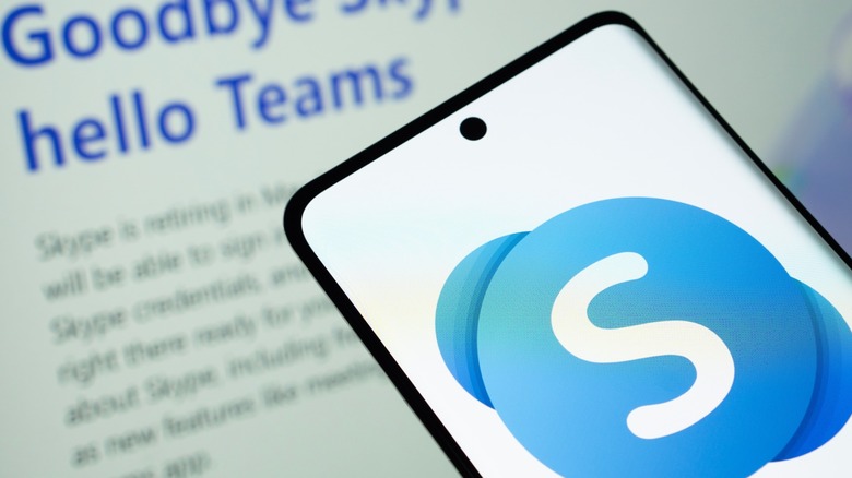 A phone with the Skype logo on the screen, set against a backdrop that reads 