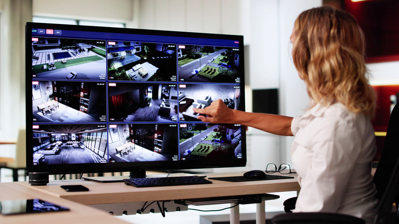 Woman looking at home security camera footage