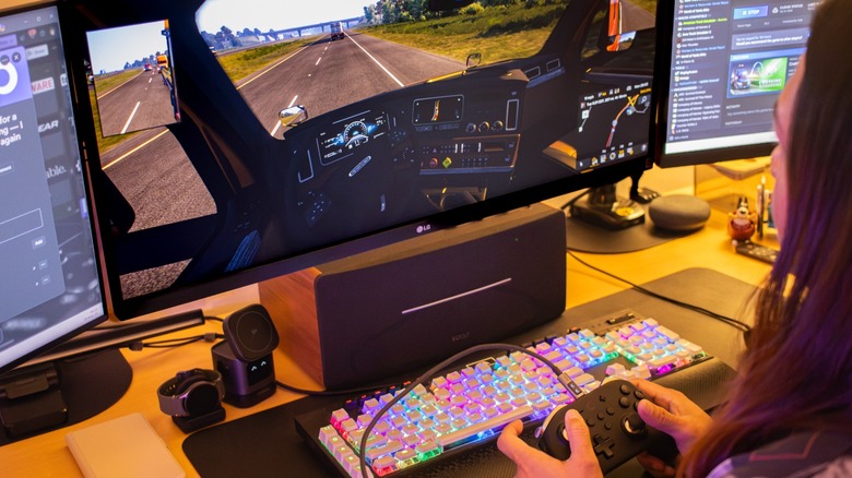 a person playing a game on a computer using a controller