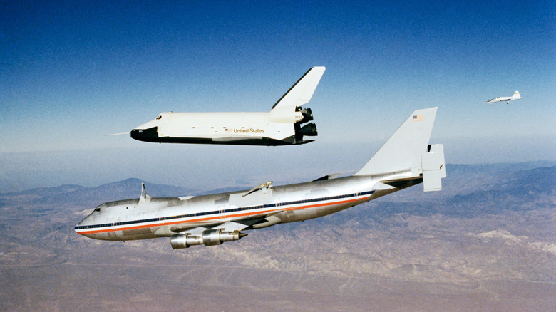A space shuttle detaching from an airplane in mid-air