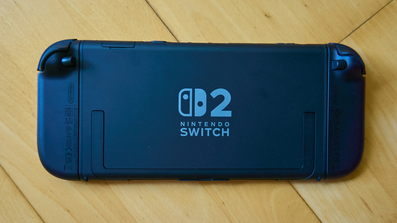 A Nintendo Switch 2 laying face down on a hardwood floor, emphasizing the Switch 2 logo