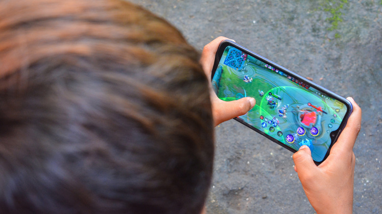 Person playing game on phone