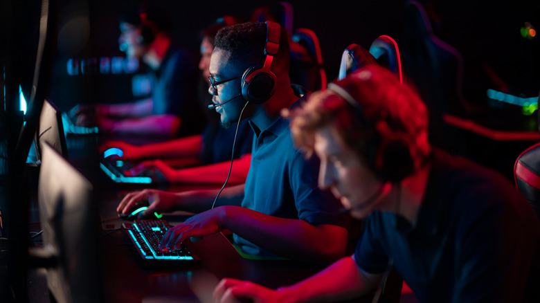 a row of pro players using their computers at a tournament