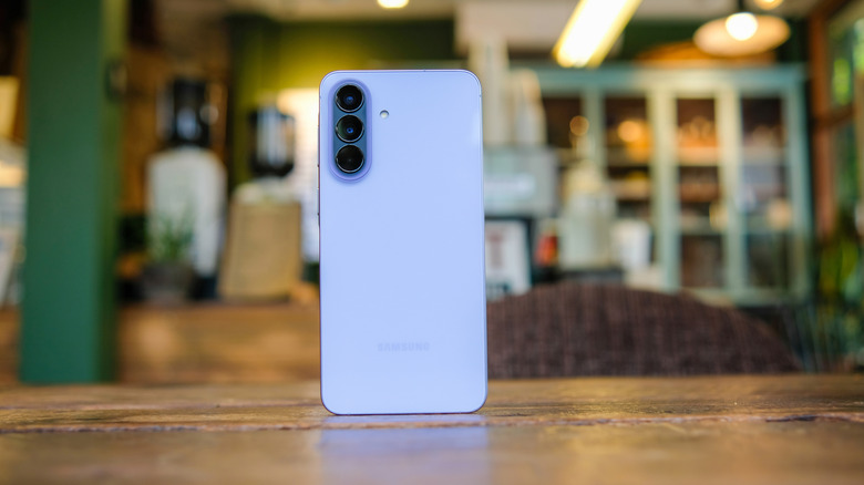 The Samsung Galaxy A57 phone standing up on a table.