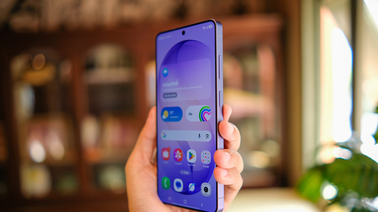 User holding a Samsung Galaxy S26 Ultra against a blurred background