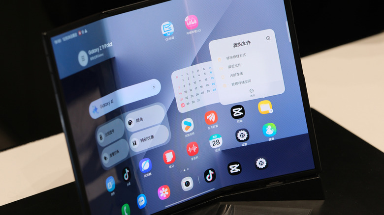 A fully opened Samsung Galaxy Z Tri-Fold spanning the width of three smartphones