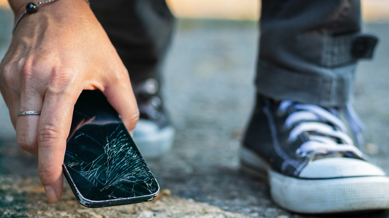 A smartphone with a damaged screen due to a drop