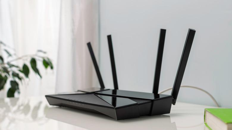 A black Wi-Fi router on a table