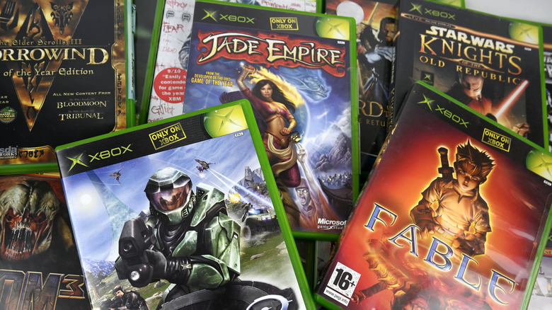 A stack of original Xbox games including Jade Empire and Fable.