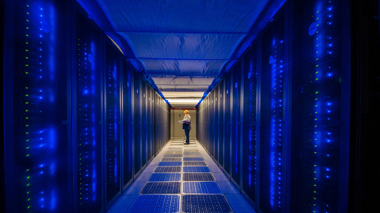 Person stood between two rows of supercomputers