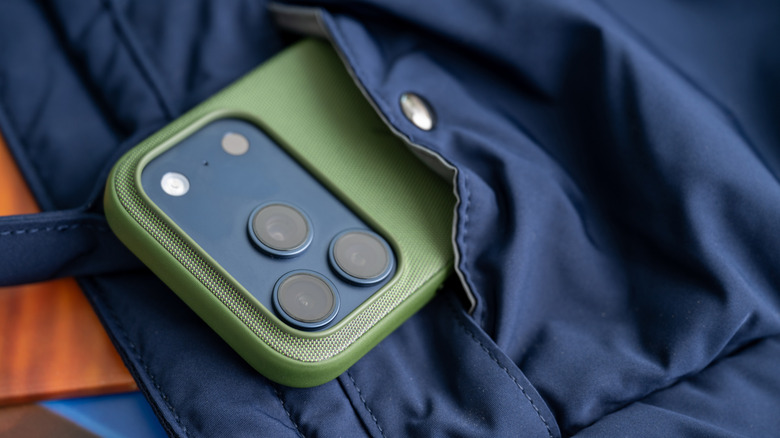 A phone with a back cover sitting inside a pocket