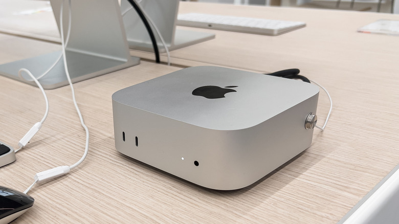 A new Apple Mac Mini computer with M4 chip on wooden table