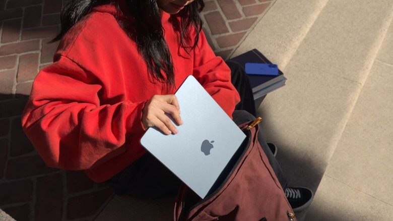 girl putting a MacBook into a bag