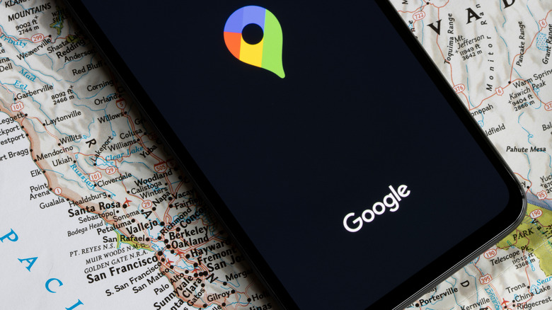 A Google Maps logo on a smartphone.