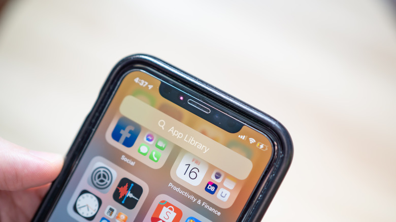 An iPhone with a glowing red light near the front-facing camera.