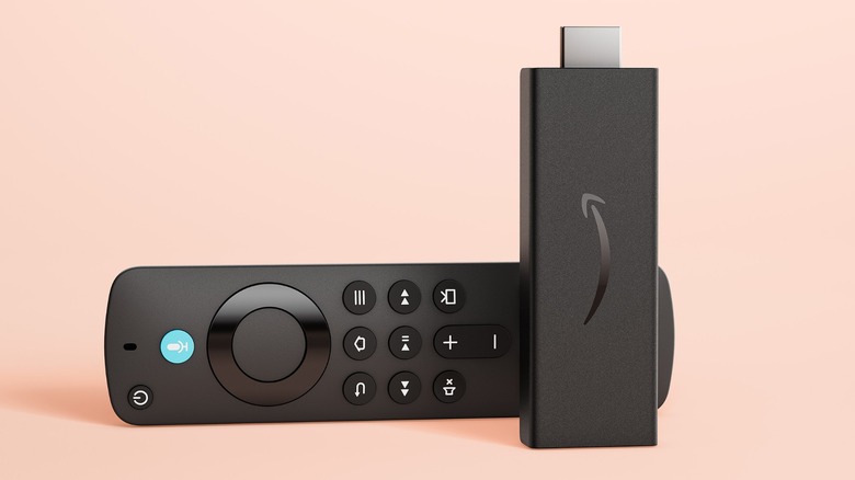 An Amazon Fire TV Stick standing vertically as its controller sits behind it laying horizontally