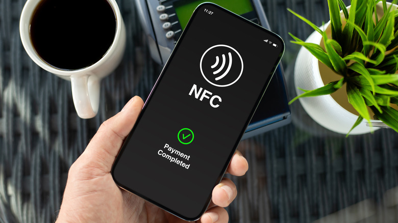 NFC technology in use on a smartphone with the logo on the screen