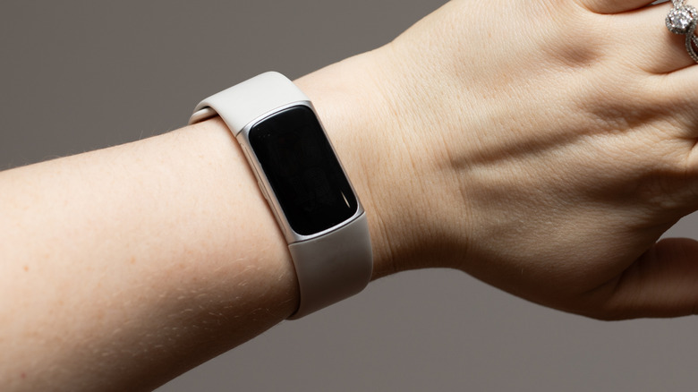 Fitbit Charge 6 tracker on a person's wrist.