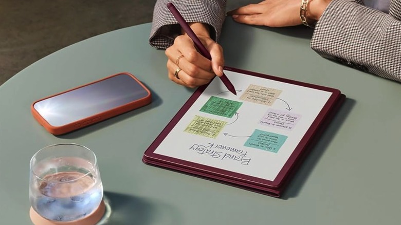 A person using an Amazon Kindle Scribe Colorsoft to take notes.