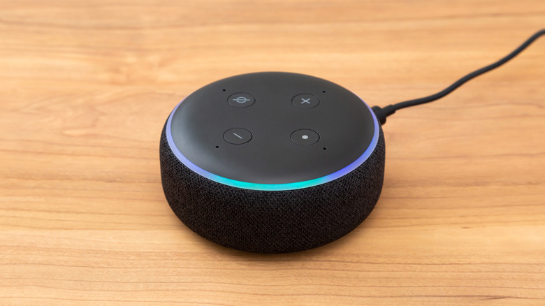 Echo Dot with illuminated light ring on a wooden surface