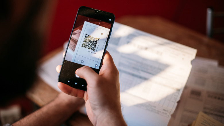 A person using a smartphone to scan important documents